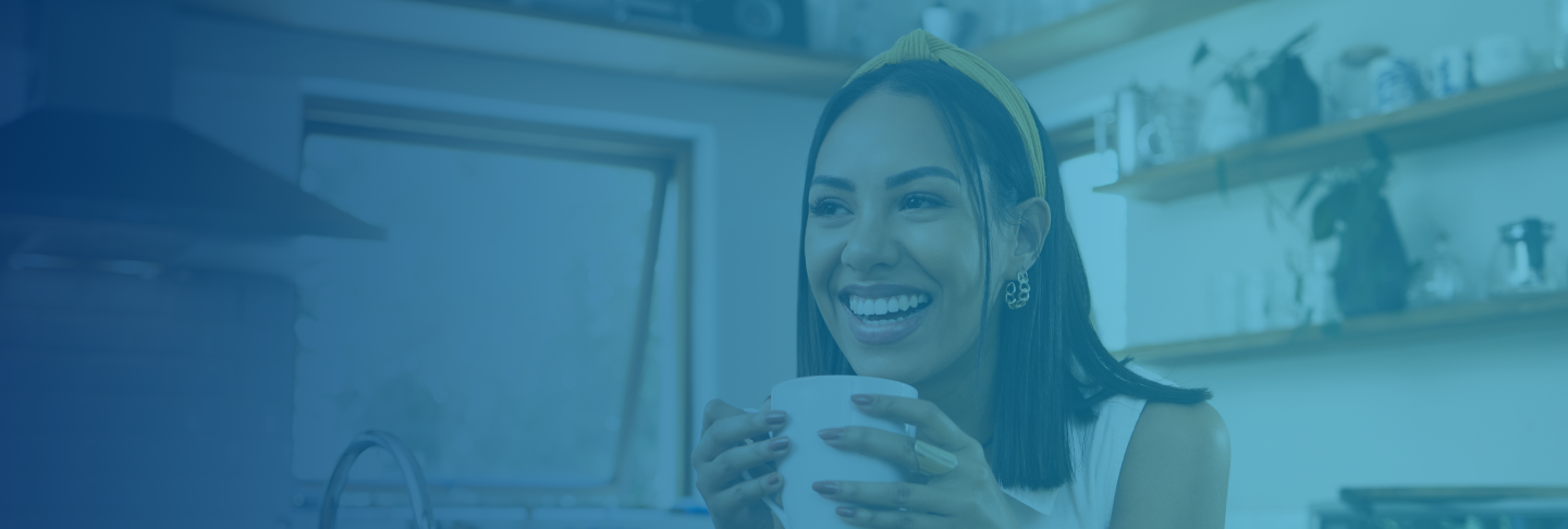 Woman enjoying coffee in her kitchen